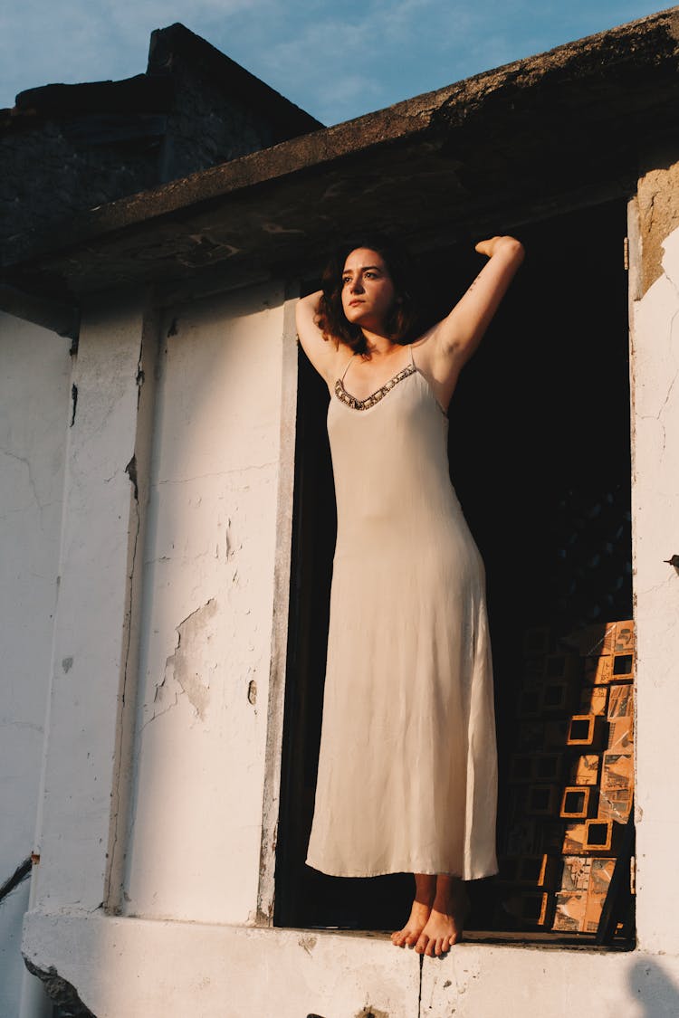 Photo Of Woman Standing In The Doorway