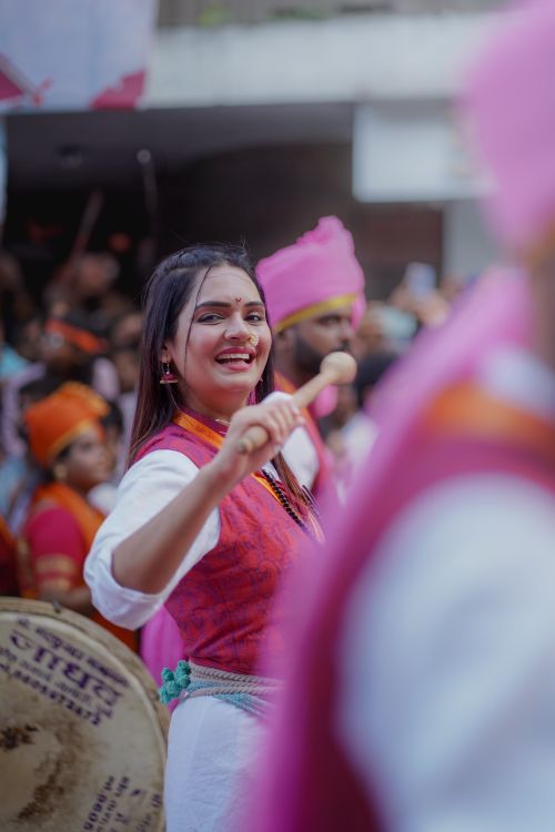 Free Joyful woman participating in a lively festival parade in Pune, India. Stock Photo
