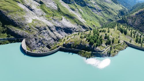 Free Aerial view of a picturesque alpine dam with turquoise waters in Korutany. Stock Photo