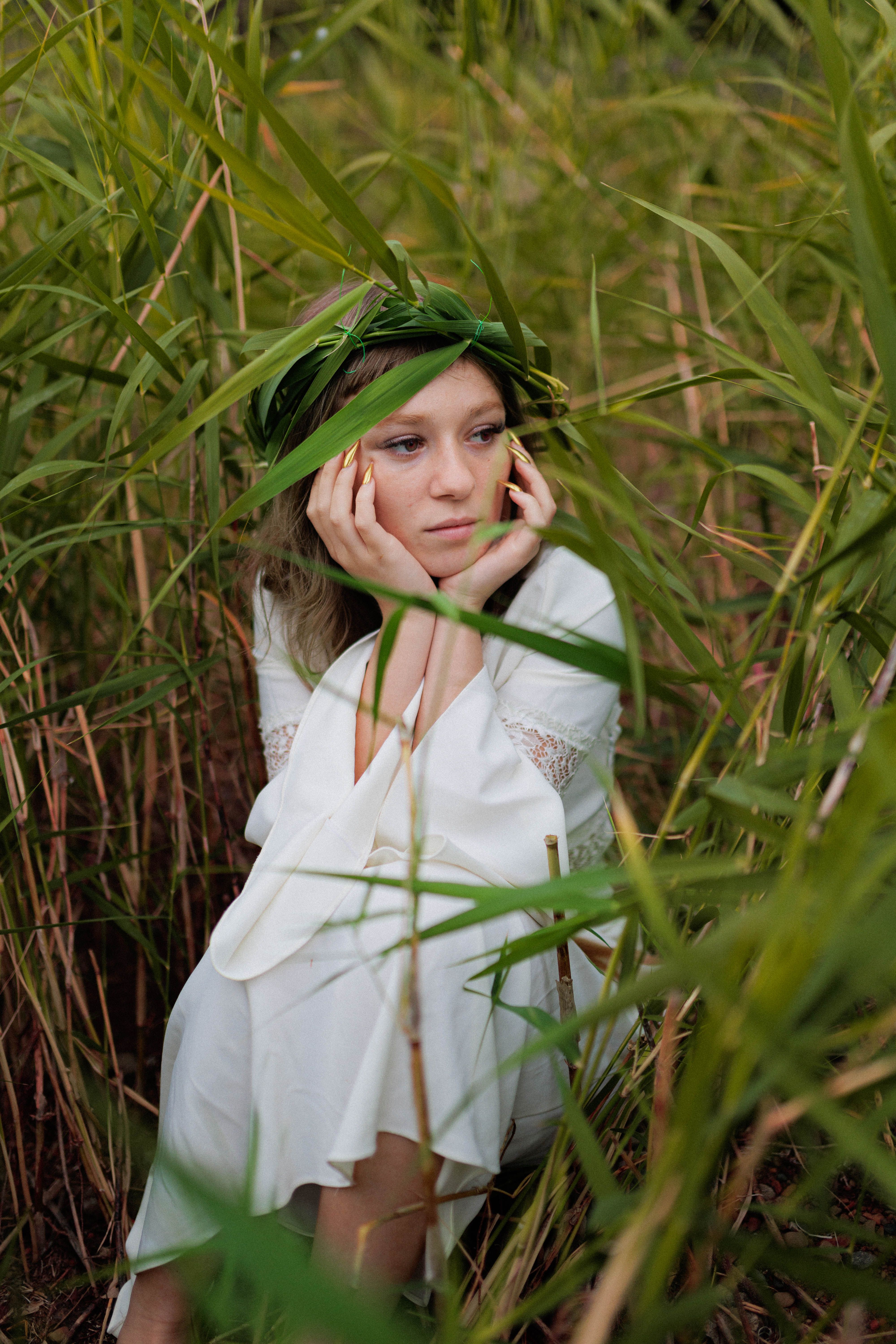 Woman in white dress amidst lush green foliage in nature · Free Stock Photo
