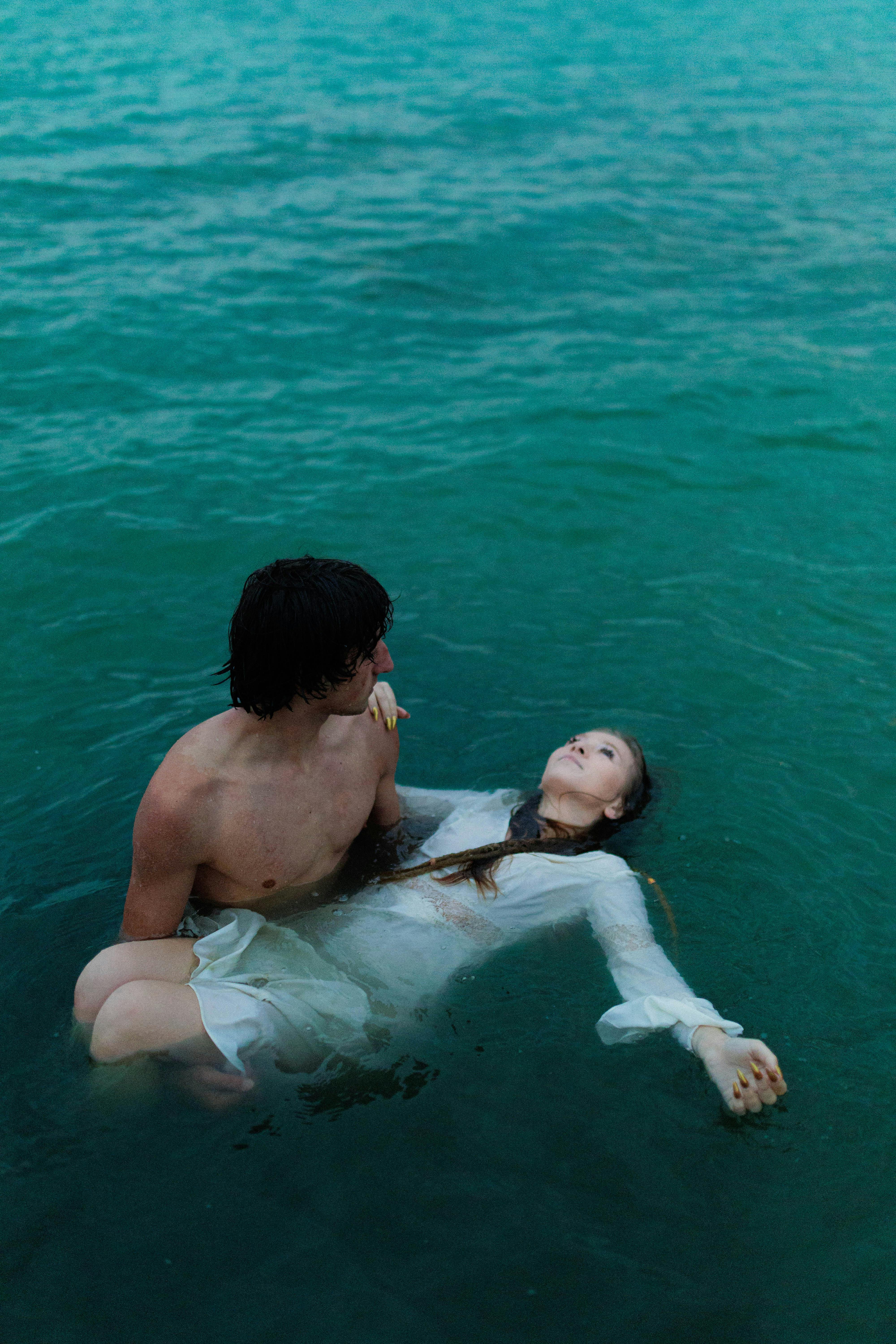 dramatic scene of two adults in water