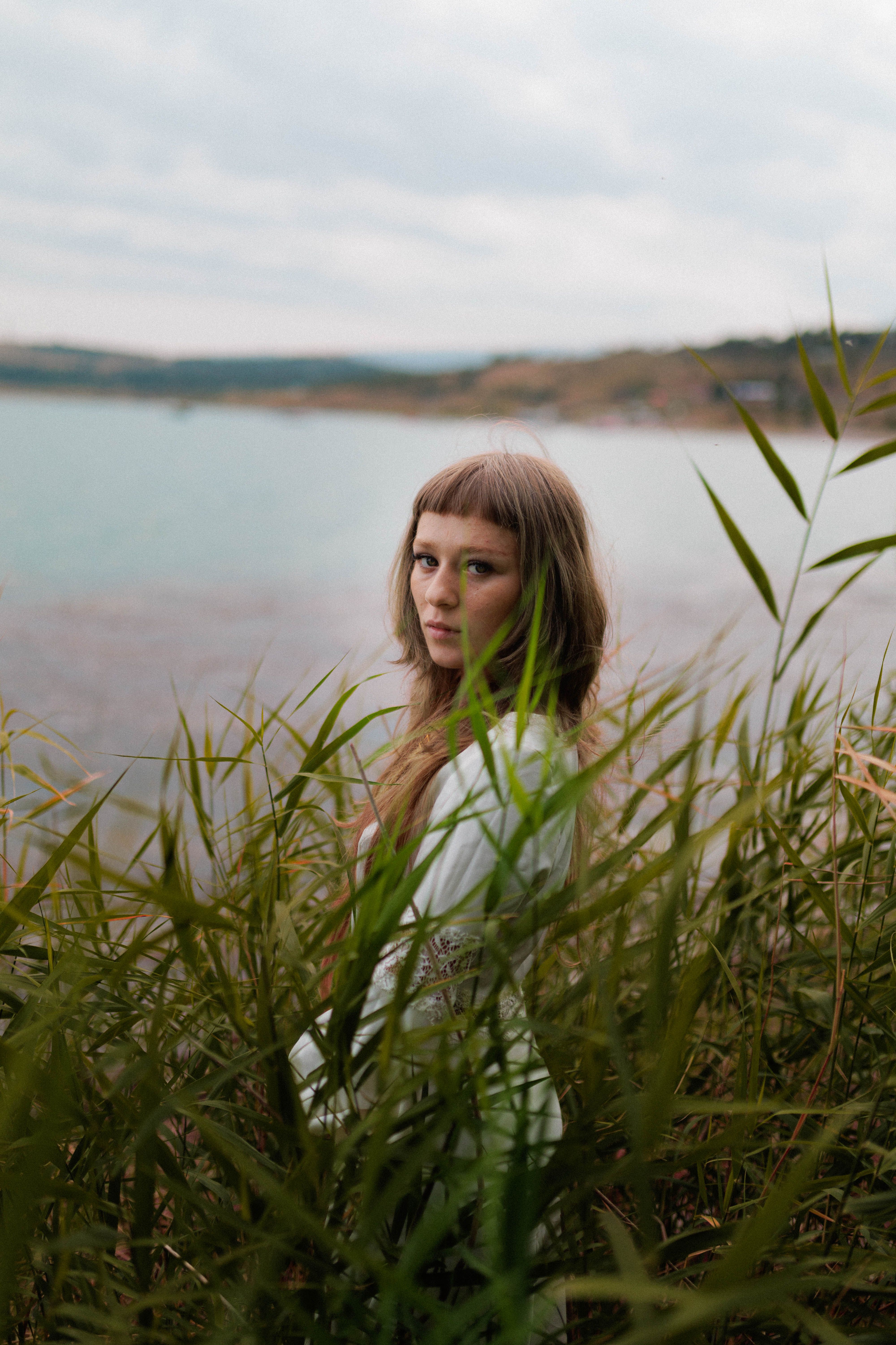Portrait of woman by a tranquil lakeside setting · Free Stock Photo