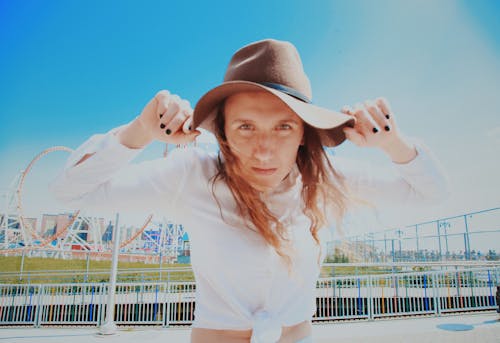 Free Photo Of Woman Holding Her Hat Stock Photo