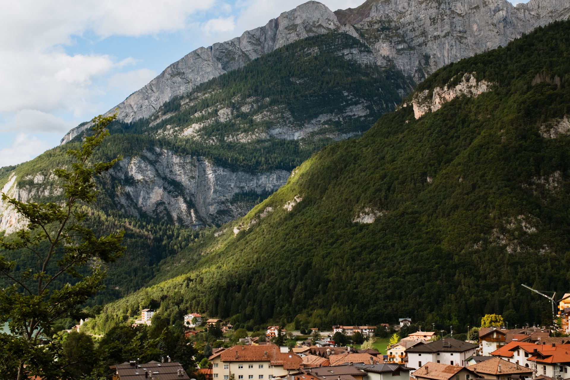 Alpine valley and village beneath the mountains near Sondrio, Valtellina