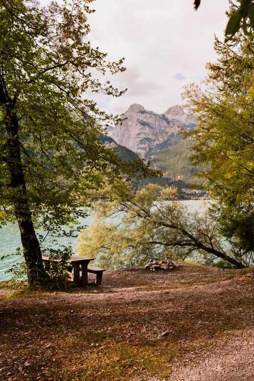 Free Tranquil scene of Lake Molveno with mountains and forest, perfect for relaxation. Stock Photo