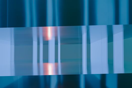 A modern abstract artwork featuring blue and orange reflections in a conceptual design.