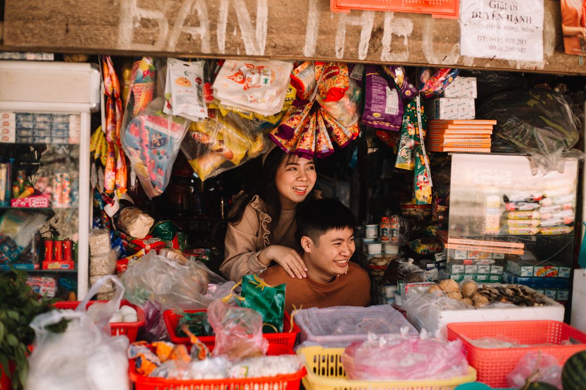 Bustling Asian market stall with vendors preparing fresh ingredients