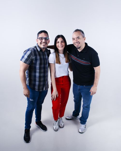Free Smiling adults in casual attire standing together against white background. Stock Photo