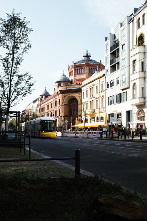 Free A bustling Berlin street scene with a tram and historic architecture on a sunny day in spring. Stock Photo