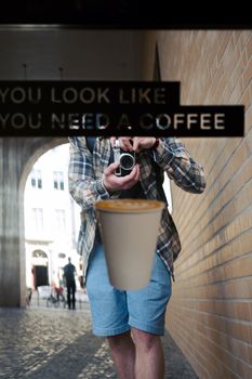 Street portrait reflection depicting a traveler holding a camera in Berlin, Germany.