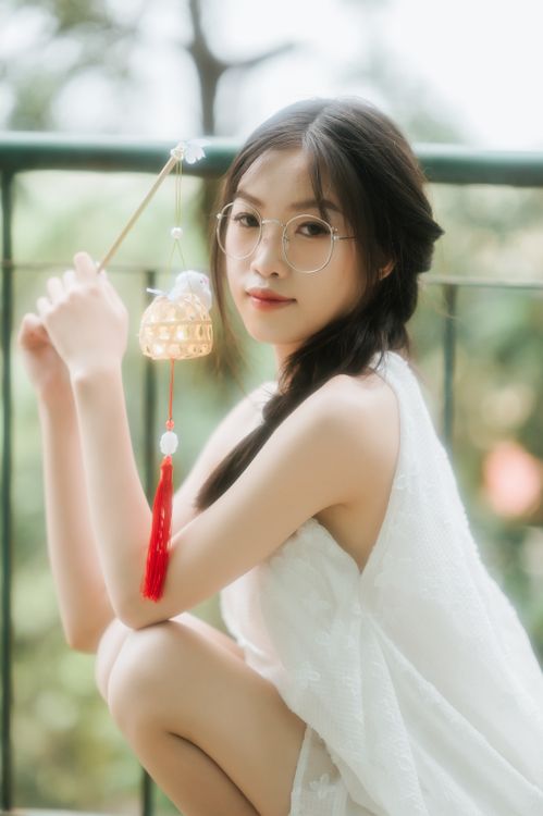 Portrait of a Young Woman Holding a Lantern Outdoors · Free Stock Photo