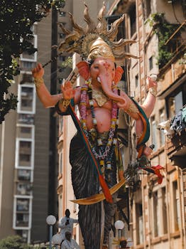 A vibrant Ganesh idol in a bustling Mumbai street during Ganesh Chaturthi festival.