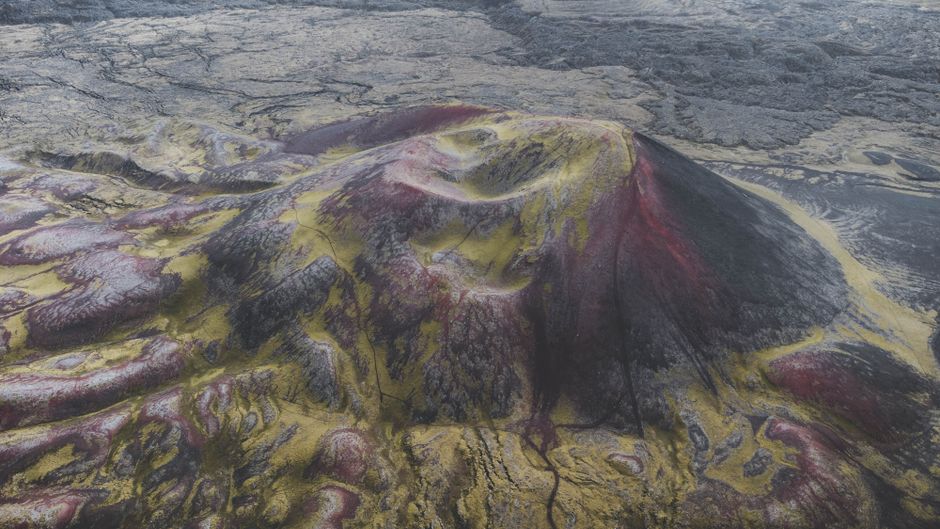 Big Island, Hawaii: Volcanoes National Park Safari - Striking aerial shot showcasing a vibrant volcanic landscape with unique red and yellow hues.