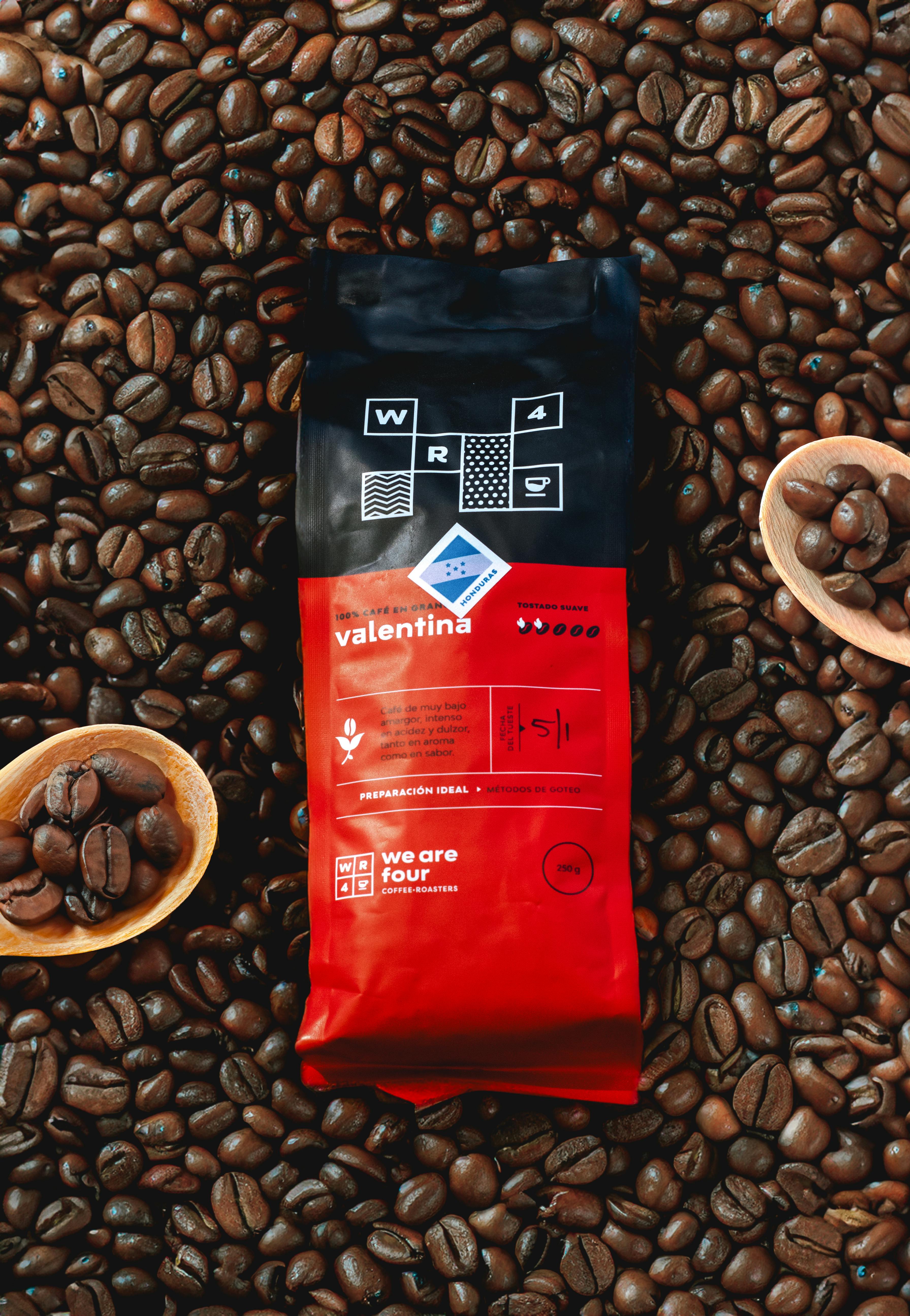 A vibrant display of coffee beans surrounding premium packaging, highlighting quality.