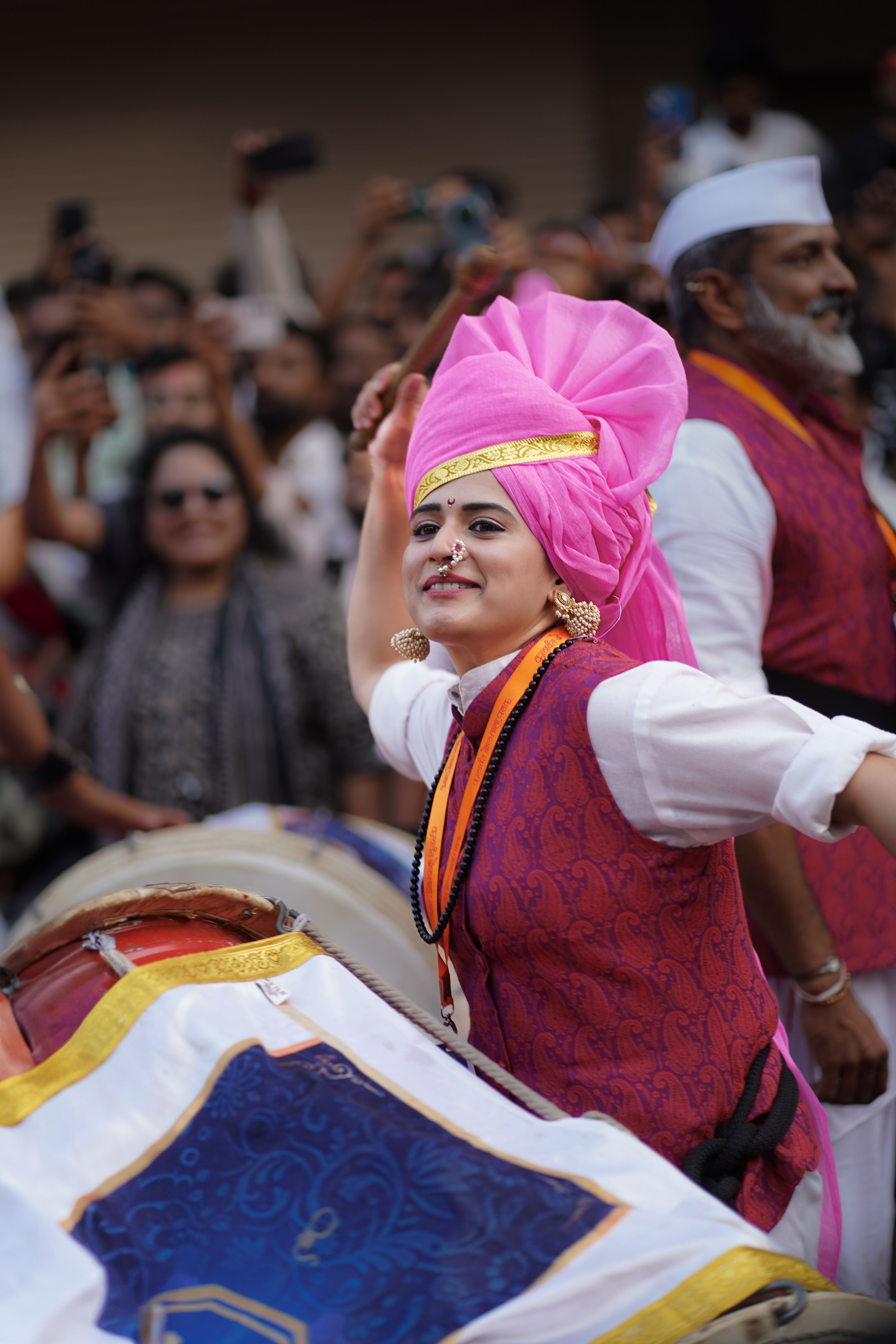 Captivating scene of a traditional Indian festival in Pune with colorful attire and joyful celebration.