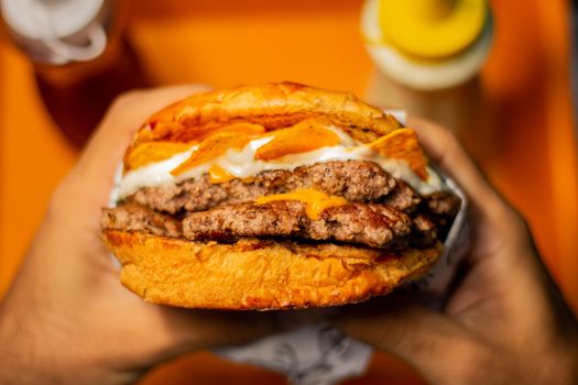 Mouth-watering close-up of a double cheeseburger with toppings.