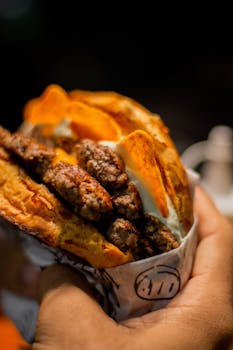 Delicious street food wrap with meat and chips in hand. Vibrant and mouth-watering.