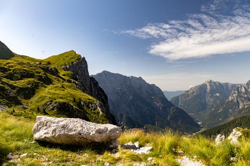 Free A picturesque view of the Julian Alps showing rugged mountains and a vibrant alpine meadow. Stock Photo