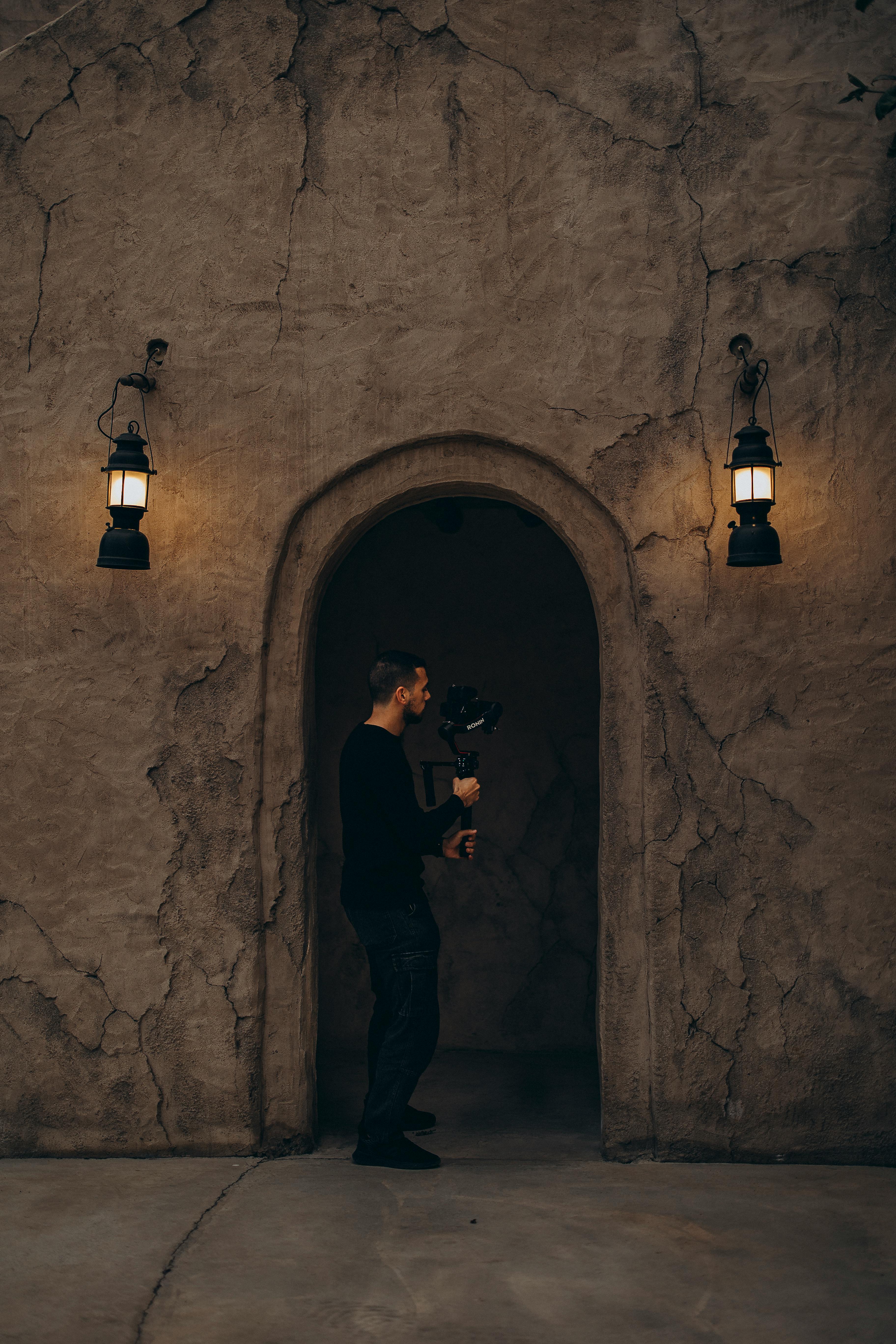 A photographer in old Dubai architecture with warm lighting ambiance.