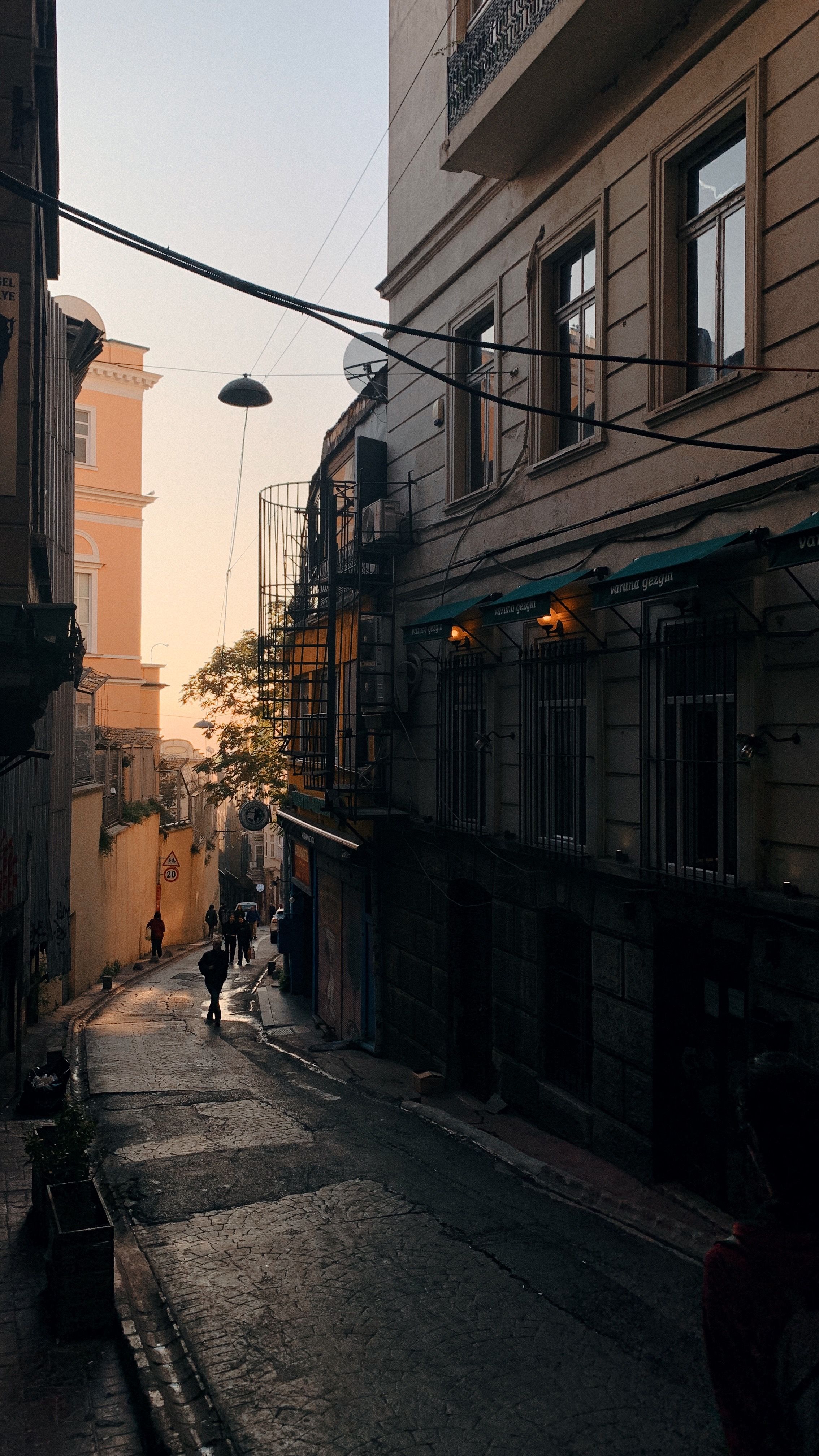 Stroll through a quaint Istanbul street at twilight, capturing the city's historic charm.