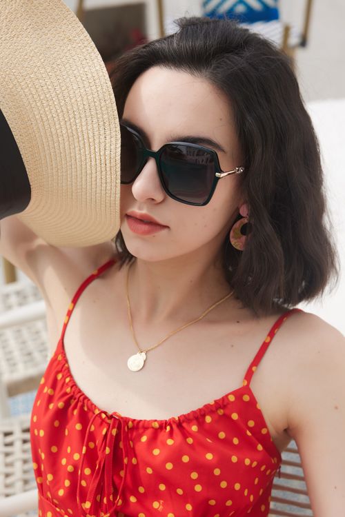Stylish Woman in Red Polka Dot Dress with Sunglasses · Free Stock Photo