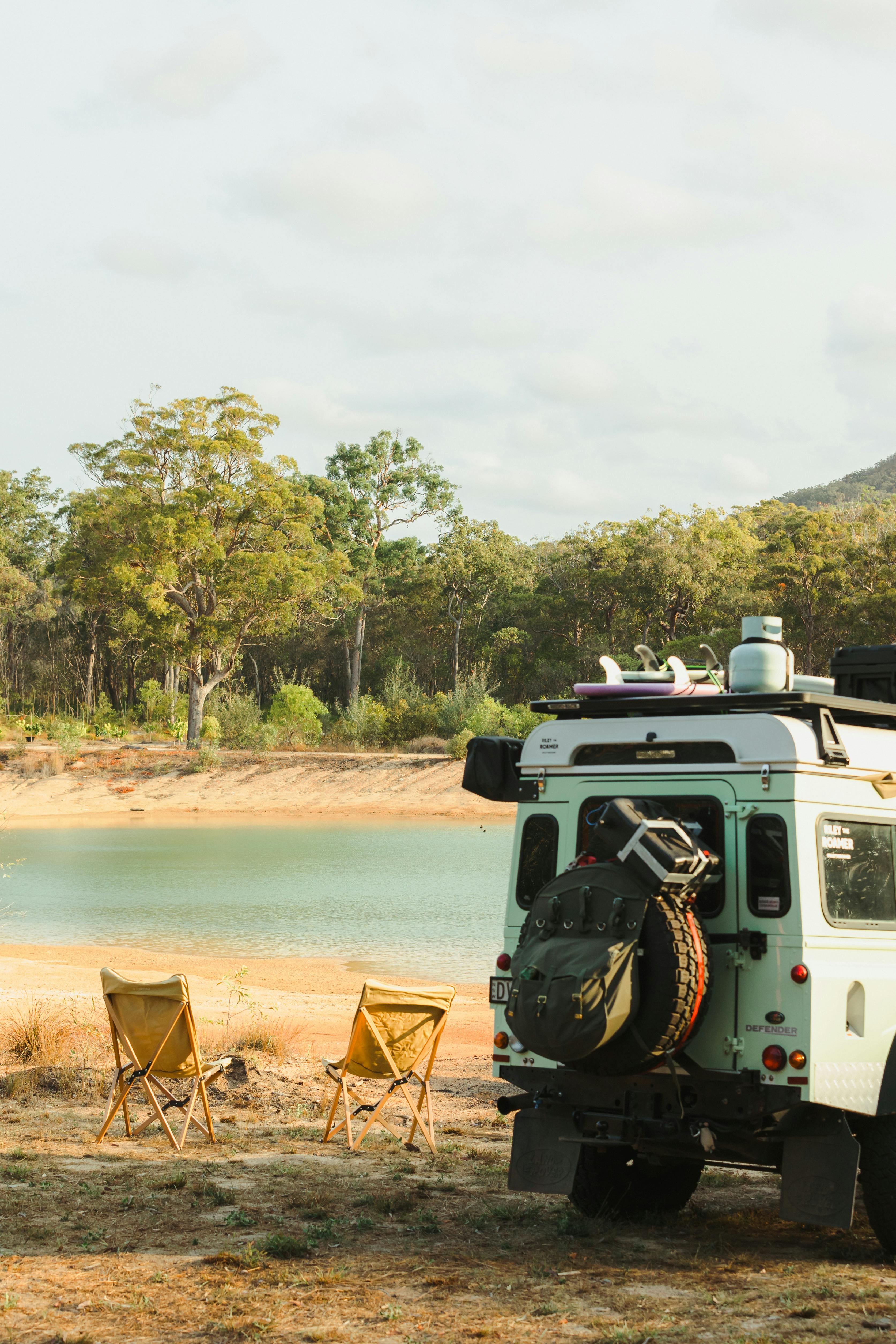 Free Off-road Camper by Serene Lake Landscape Stock Photo