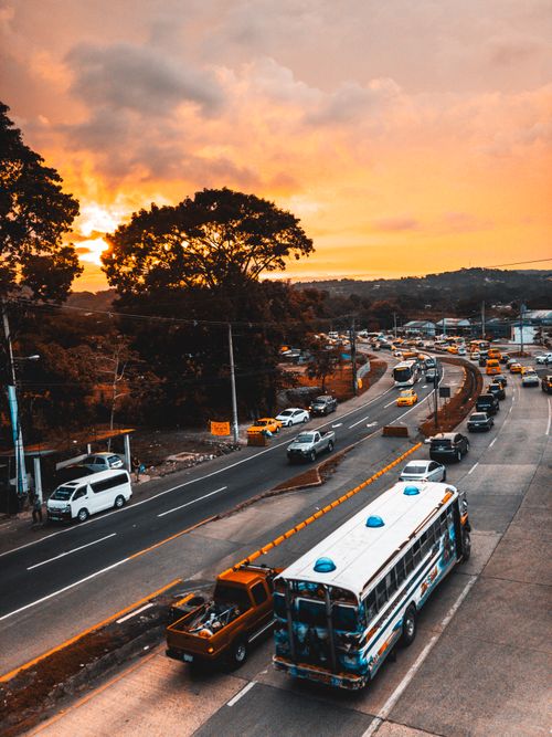Free Aerial view of a lively highway at sunset with vibrant sky and heavy traffic. Stock Photo