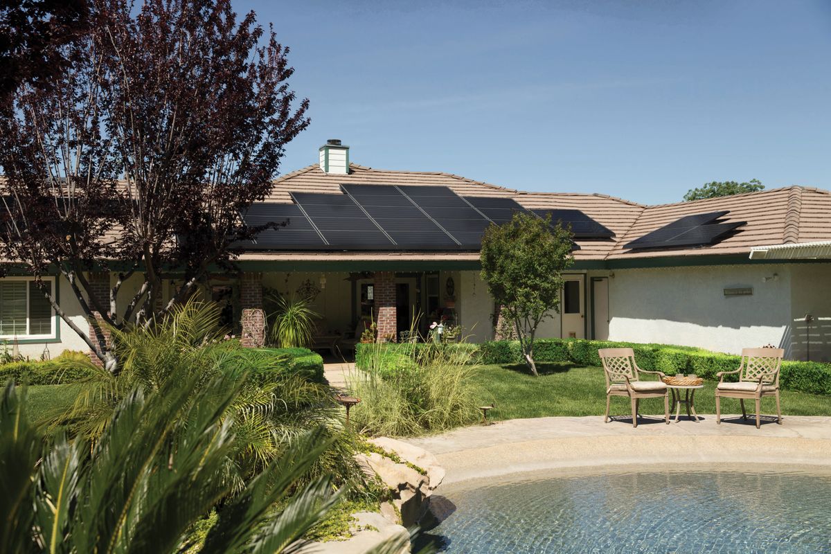 Residential home with rooftop solar panels — home battery and solar backup adoption surging nationwide