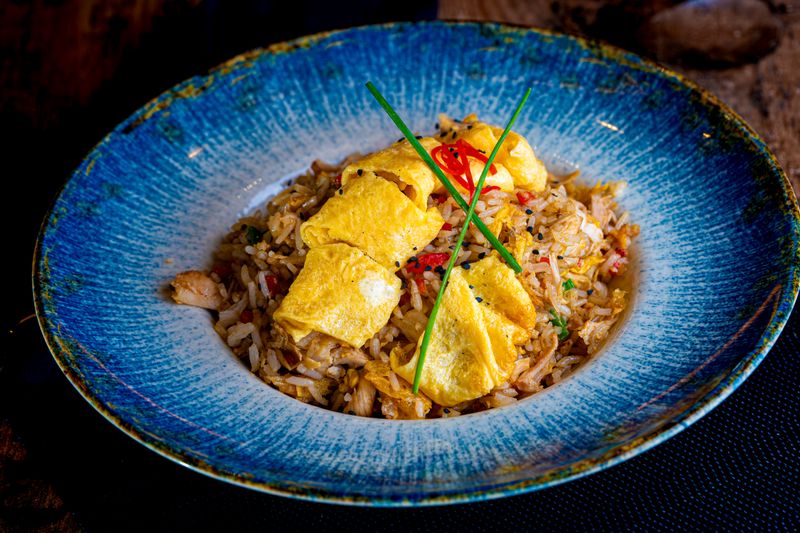 fried rice with egg and scallions in a pan