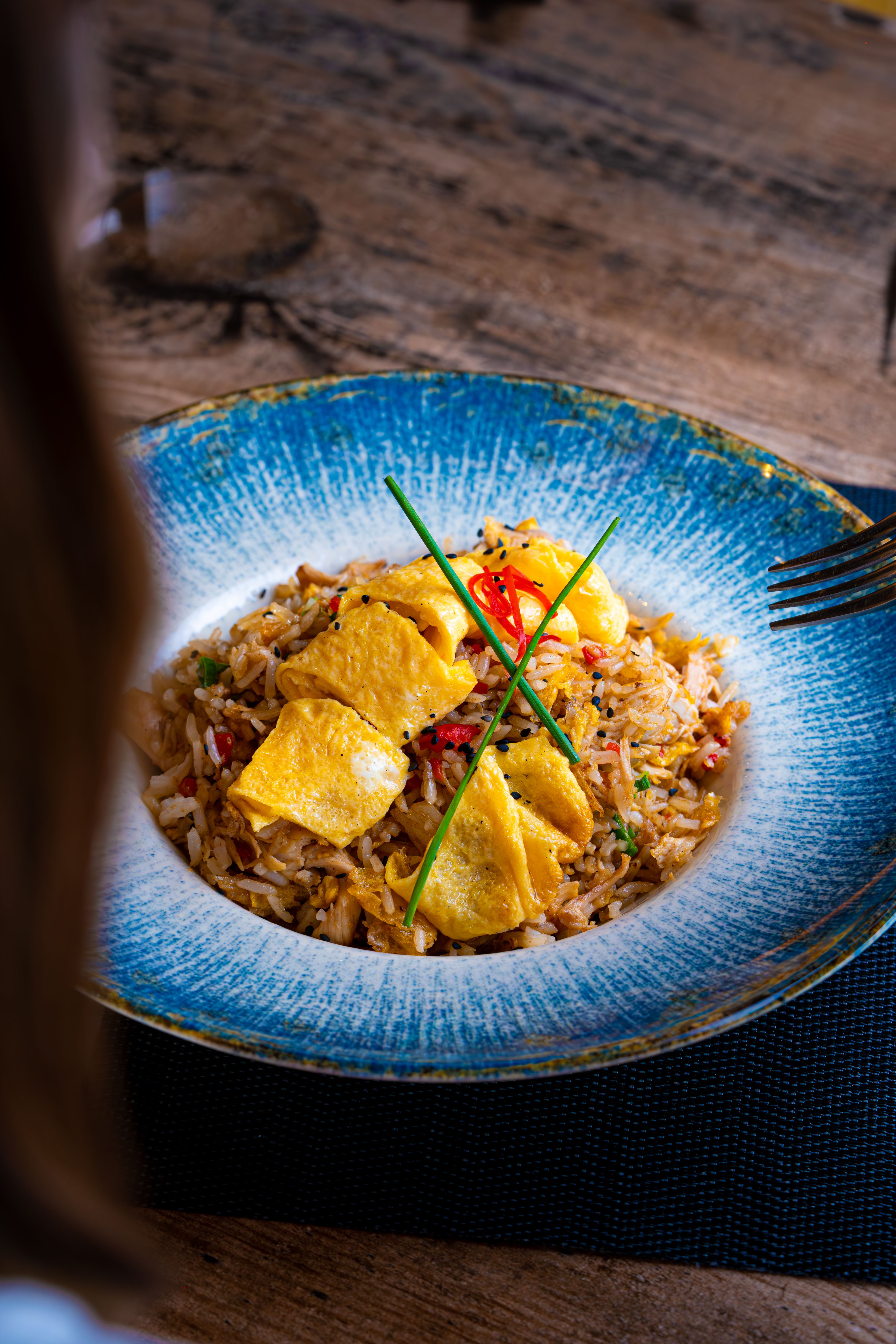 Gourmet Fried Rice with Egg Garnish in Blue Bowl · Free Stock Photo