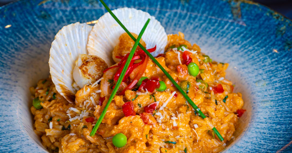 Seafood paella with shrimp, mussels, and squid in a traditional large paella pan.