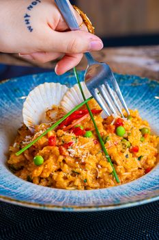 Delicious seafood risotto with scallops and vibrant vegetables.