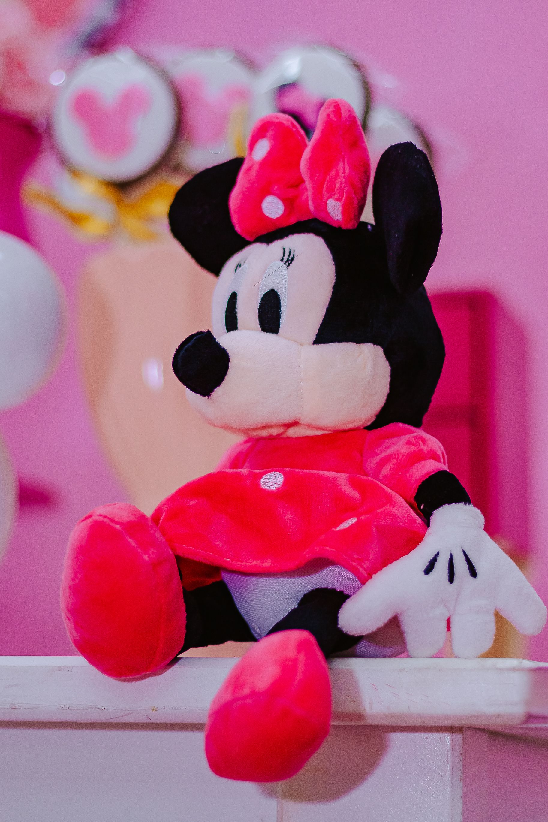Vibrant Minnie Mouse plush toy on display in a lively setting.