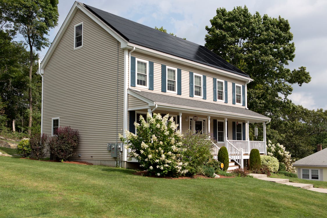 White 2-story House with solar panels on roof