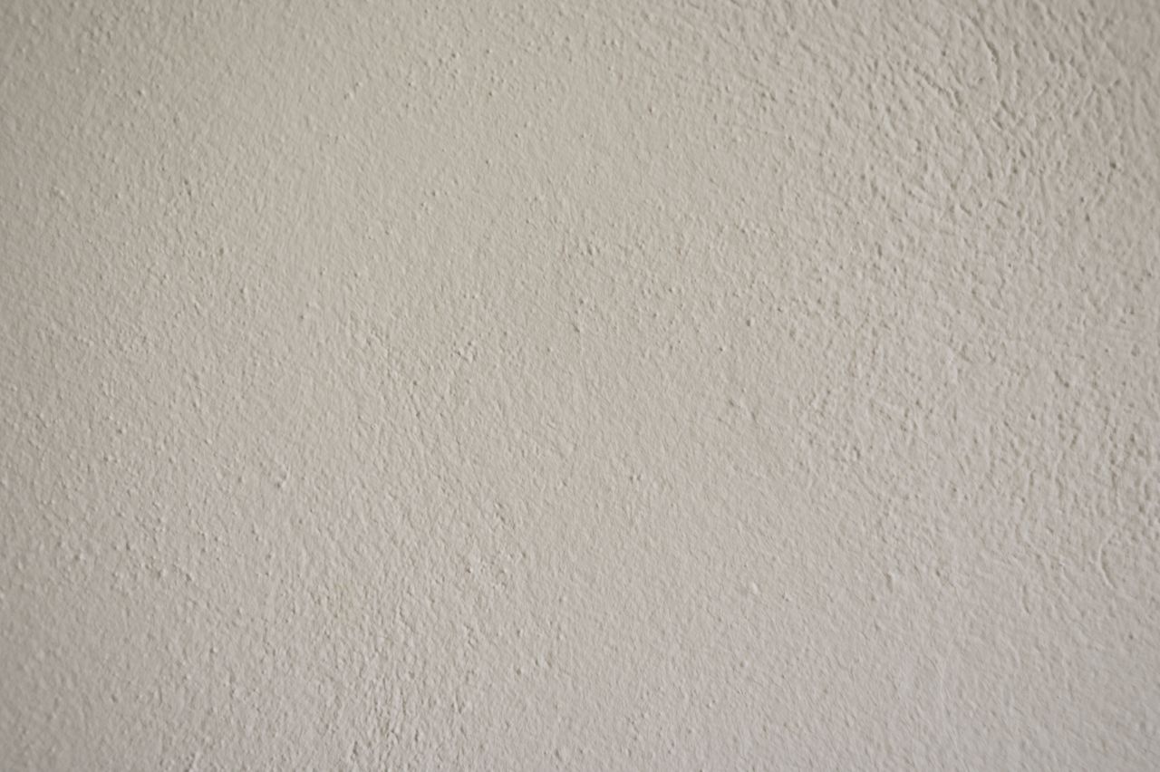 a close up view of a textured white wall suitable for creative design