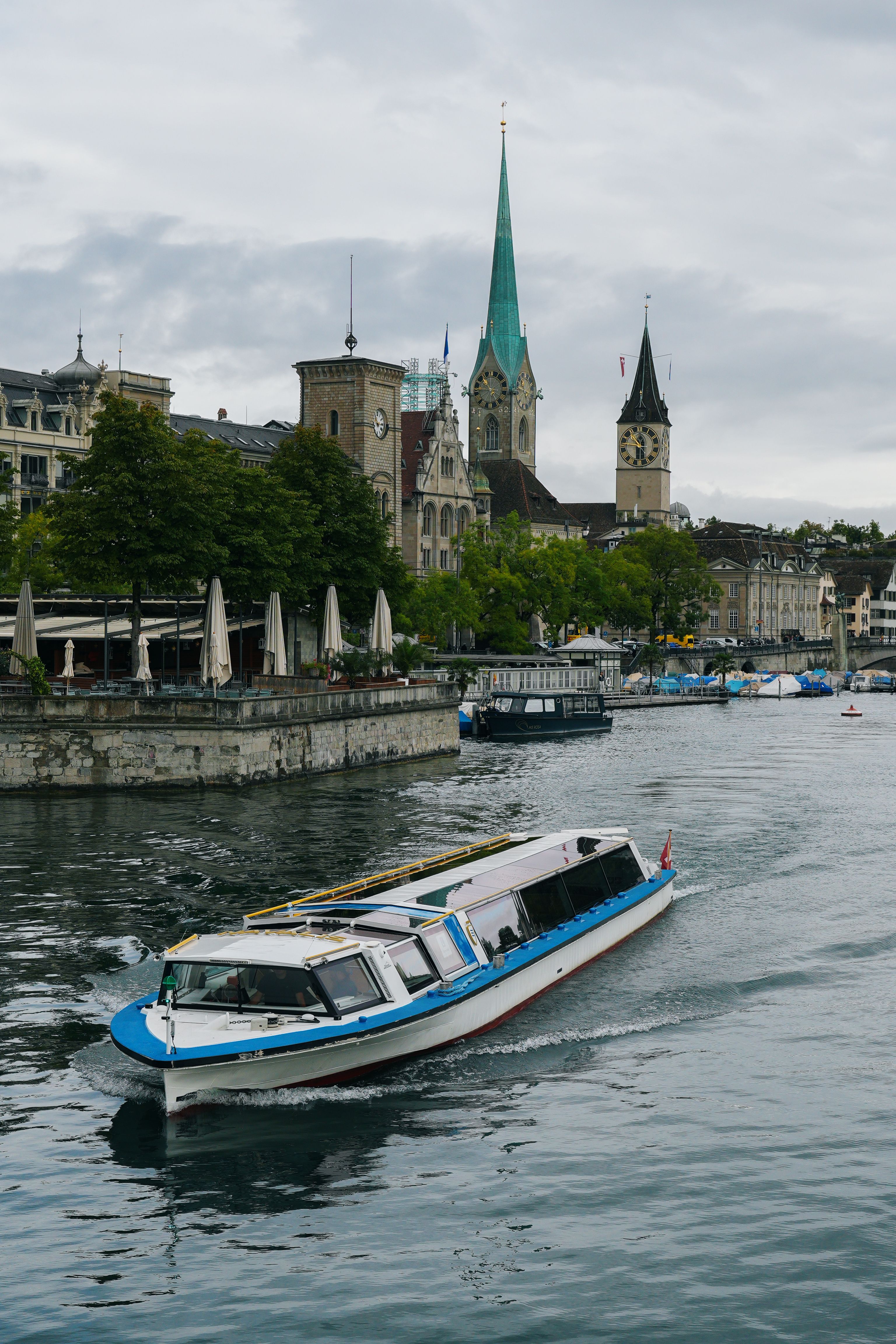 A picturesque boat journey on the River Limmat with Zürich's historic architecture in the background.