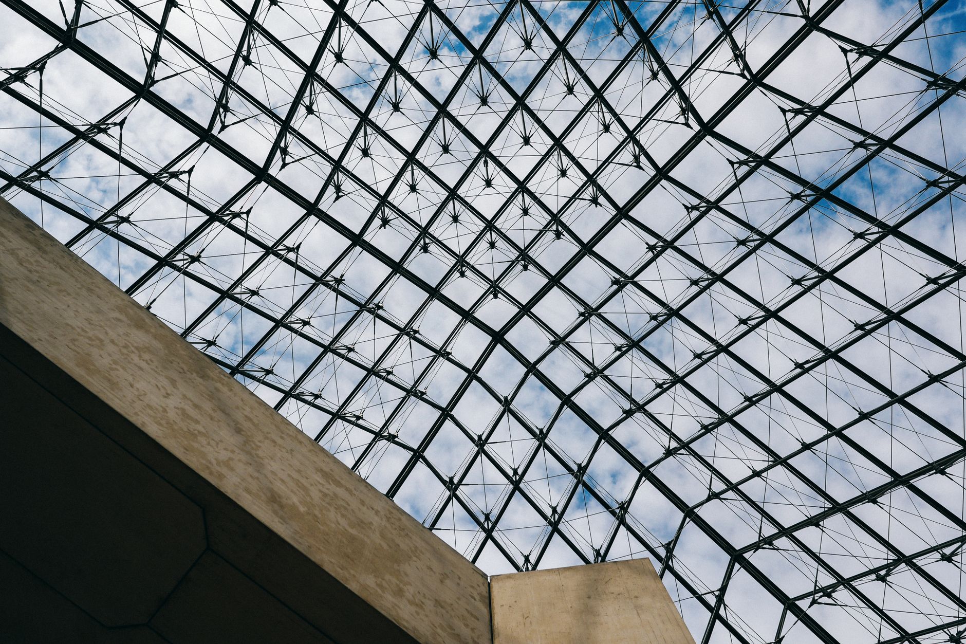 View of the geometric glass structure at a famous museum in Paris.