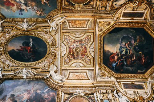 Free Detailed view of Baroque ceiling art at a historic museum, showcasing classical paintings and ornate decorations. Stock Photo