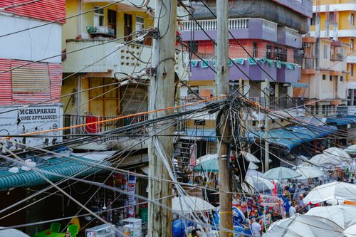 Free Vibrant market scene with tangled electrical wires in an urban setting. Stock Photo