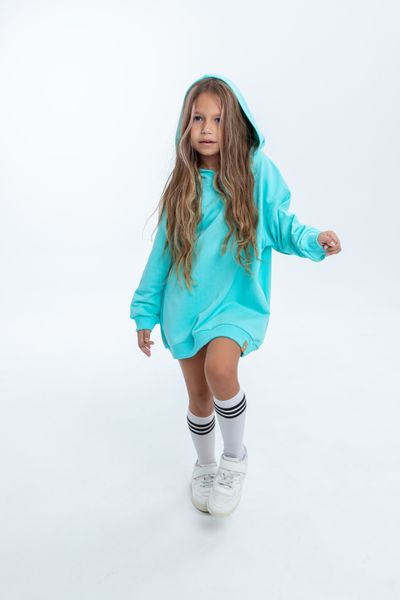 Child in a blue hoodie and white sneakers