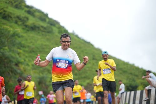 Free A group of marathon runners enjoying an outdoor race through lush green hills. Stock Photo
