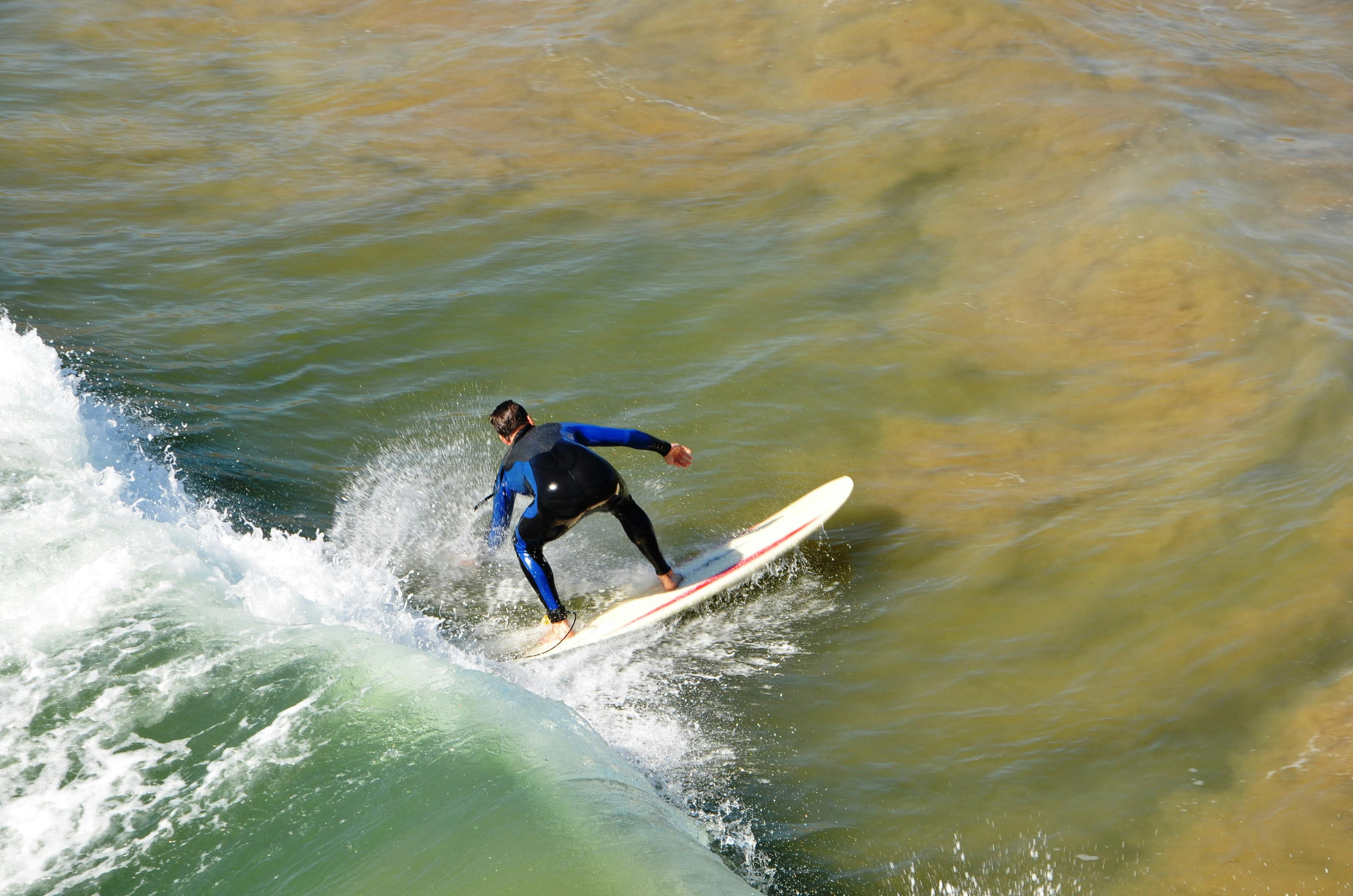 Surfer skillfully navigating ocean waves, showcasing balance and technique.