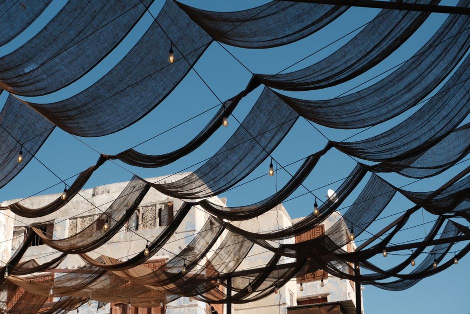 Elegant draped canopies over historic architecture in Jeddah, capturing Arabian heritage.