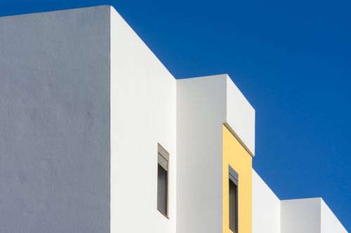 Free Abstract view of a contemporary building facade with blue sky background. Stock Photo