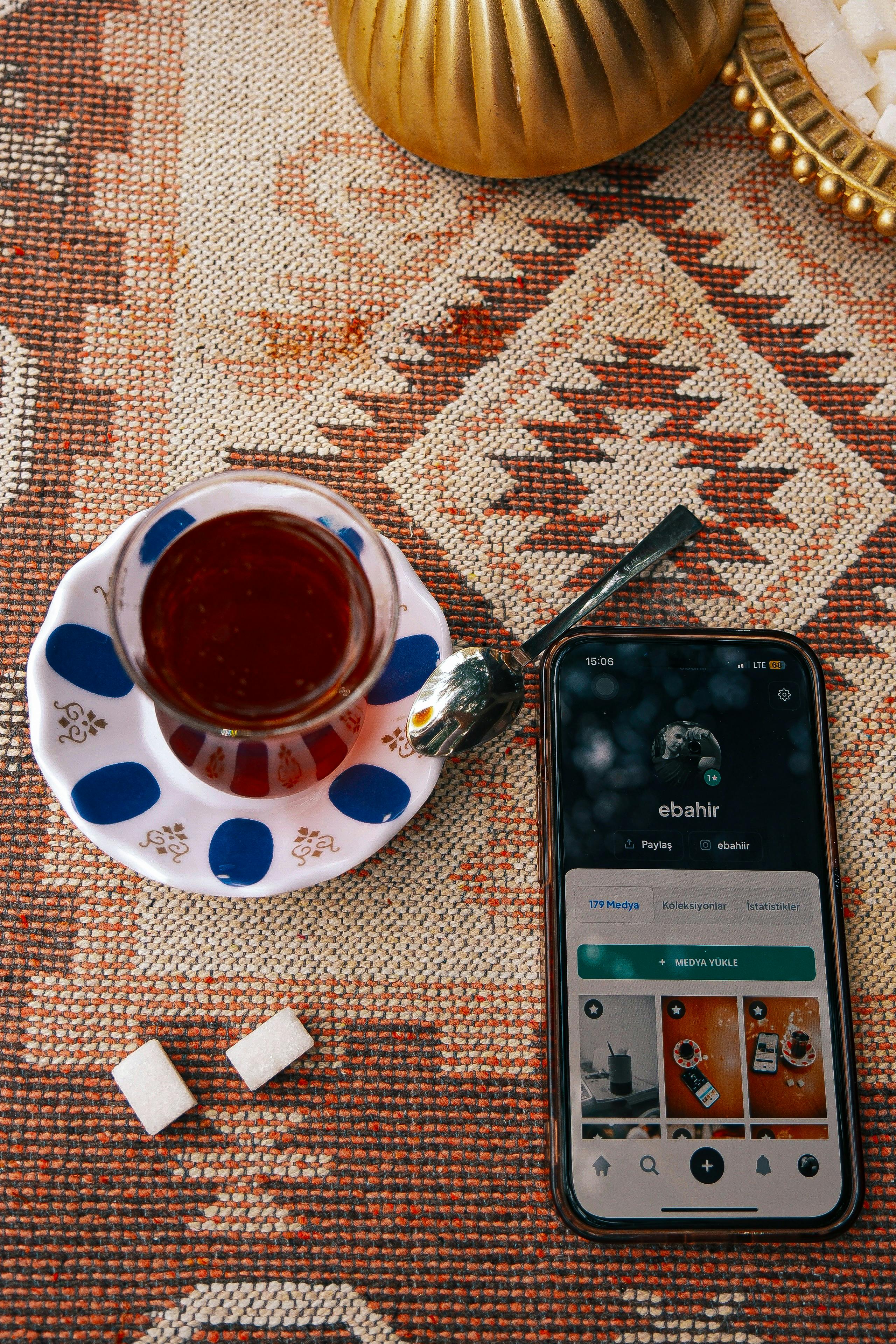 cozy tea setup with smartphone device on rug