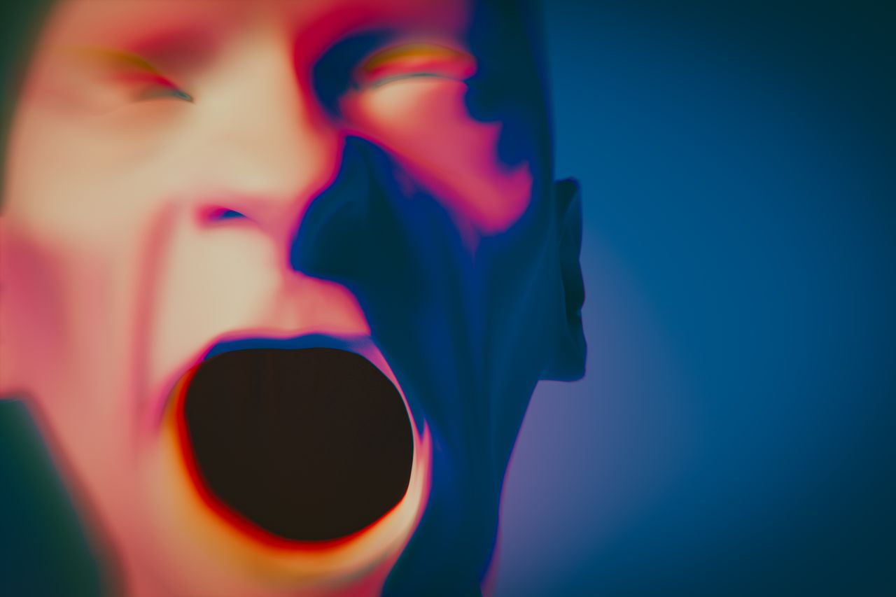 a vibrant abstract depiction of a human face conveying strong emotion