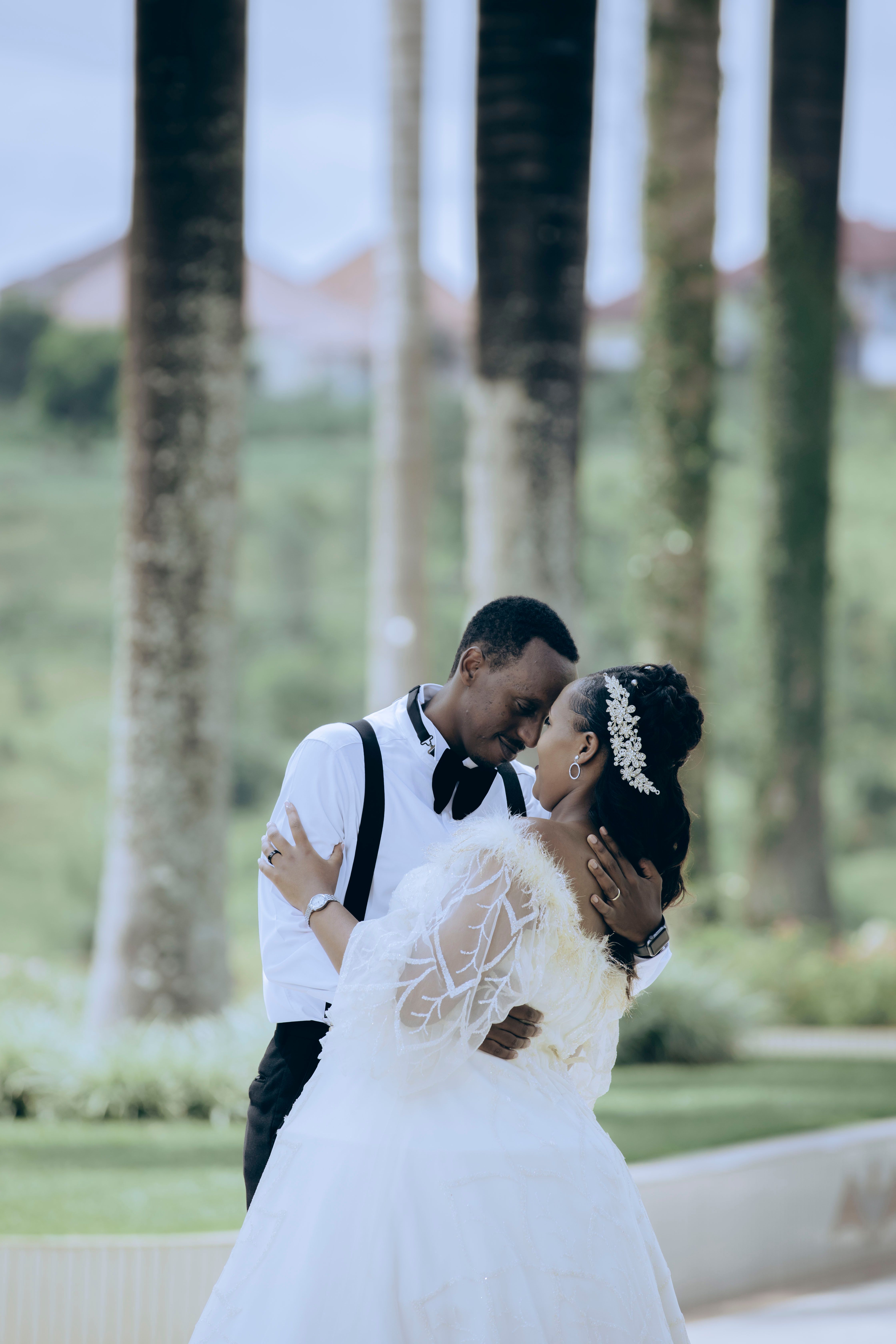 Romantic Wedding Couple Embracing Outdoors · Free Stock Photo