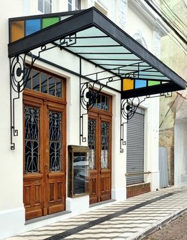 Elegant Art Deco facade with stained glass canopy in Cachoeira do Sul, Brazil.