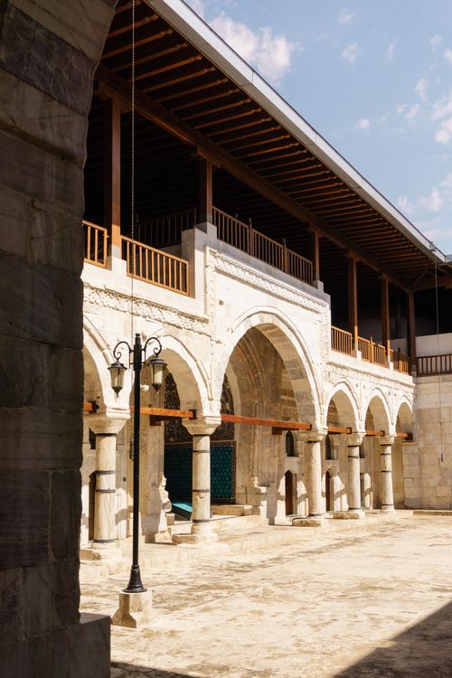 Free This image captures a historic stone building featuring arched architecture and ornate details. Stock Photo