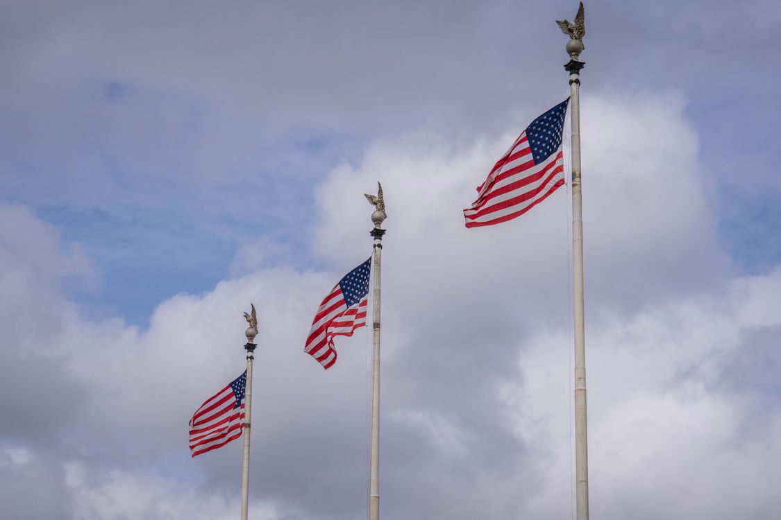 Free American Flags Against a Cloudy Sky Stock Photo
